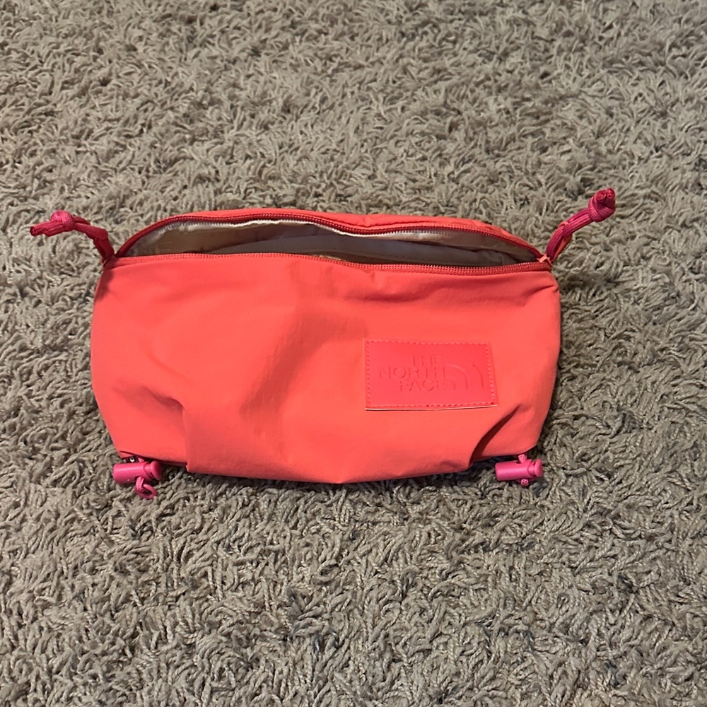 Reddish pink north face bag